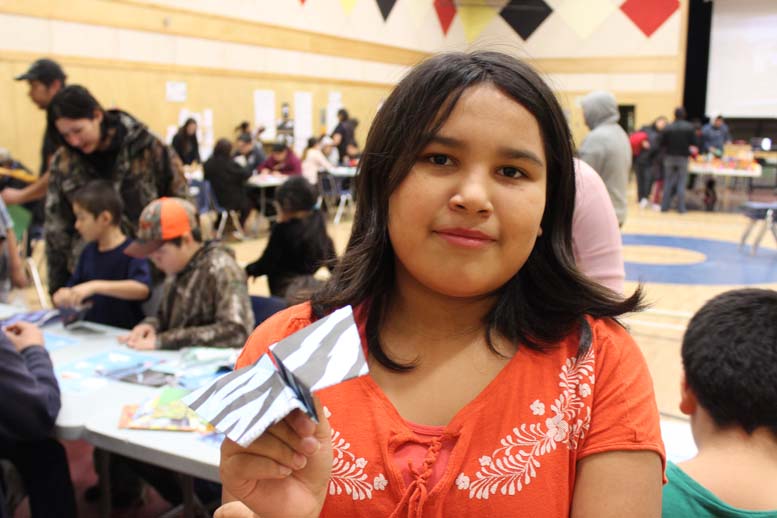 Student showing off her paper airplane