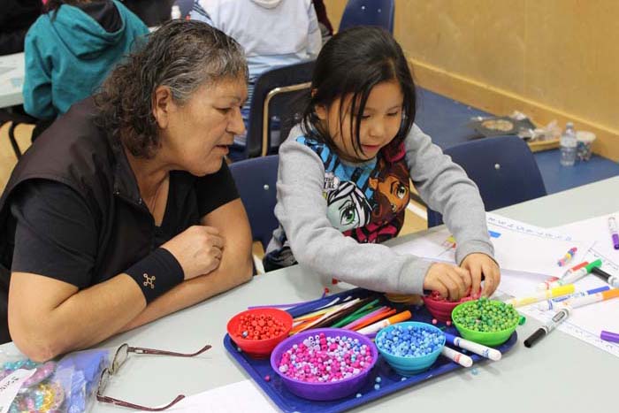 Student playing with beads