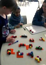 Students experiment to create the 12 different pentomino configurations